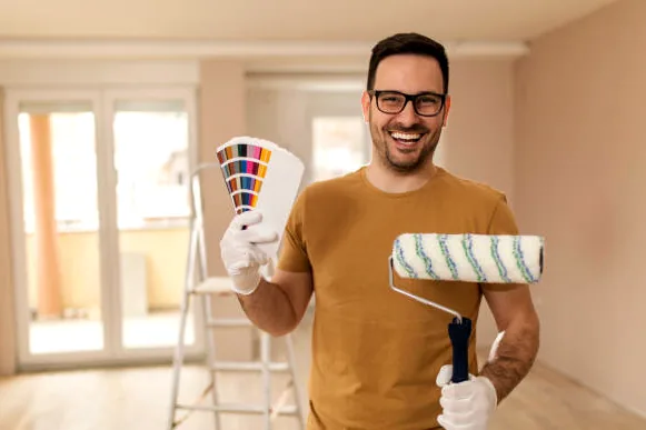 Chatsworth painter holding a roller and fan deck